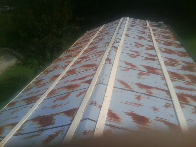 Rusted metal roof panels with new wood purlins before replacement — Storm Damage Roof Repair in Hayfork by Roofing Brothers